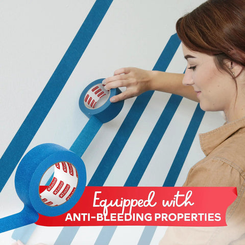 Person applying Blue Painter Tape 2 Inch By 60 Yards Bulk 12 Roll Pack with Sharp Edge Line Technology on wall trim for crafts.