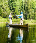 Two people fishing on a canoe with a Hydrodynamic Canoe Stabilizer Float Kit With Gray Floats Adjustable Universal Receiver Fit Low Drag Stability