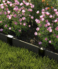 Metal Landscape Edging Stakes Kit With Twenty Pieces Eight And A Half Inch Garden Anchors installed between grass and flowers.