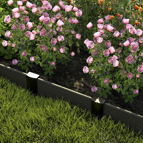Metal Landscape Edging Stakes Kit With Twenty Pieces Eight And A Half Inch Garden Anchors installed between grass and flowers.