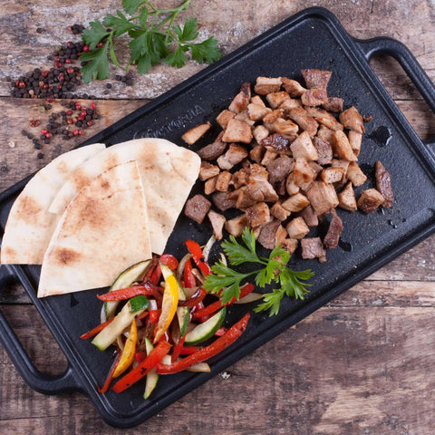 Two Burner Cast Iron Griddle, Reversible Grill Pan, 13 By 8.5 Inches, Ready To Use With Kosher Certified Non GMO Flaxseed Oil Seasoning, No PTFE Or PFOA, Built Tough And Heat Retentive, with cooked meats and vegetables.