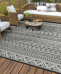 Waterproof 5x8 Outdoor Rug Mat For Patio Balcony RV Camping And Beach Reversible Boho Gray Plastic Straw Pattern on deck