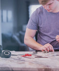 Person assembling Beast Mode Erector Set Metal Model Kit For Adults Teens And Advanced Kids Build Cars Planes And Excavators