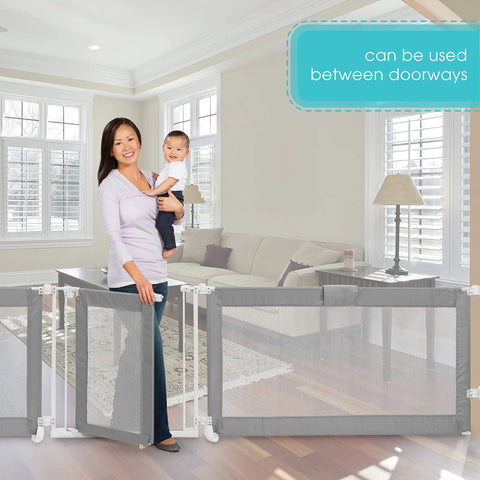 Woman holds baby near Custom Fit Walk-Thru Extra Wide Baby Gate For Openings 65 To 141 Inches, 30-Inch Tall, Hardware Mounted, Grey.