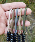 Pace Count Beads For Land Navigation Kit with black beads on rugged nylon cords in multiple colors for hiking and orienteering.