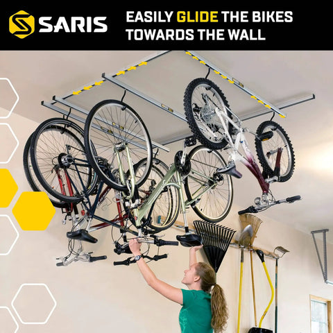Glide Ceiling Bike Rack Storage For Up To Four Bikes With Individual Access installed in garage with bikes hanging
