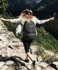 Person hiking with 40L Lightweight Packable Hiking Backpack With Wet Pocket Waterproof Daypack For Travel Camping And Outdoor Adventures