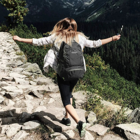 Person hiking with 40L Lightweight Packable Hiking Backpack With Wet Pocket Waterproof Daypack For Travel Camping And Outdoor Adventures