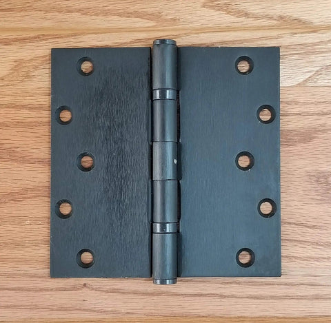 Heavy Duty Commercial 6 Inch Square Ball Bearing Door Hinges Oil Rubbed Bronze 2 Pack with smooth pivot design on wood background.