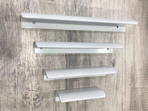 Four white arc edge drawer pulls displayed in varying sizes on a wooden surface. Six Pack White Arc Surface Drawer Pulls For Furniture Cabinets Edge Mount Hidden Cabinet Handles With 64 Millimeter Hole Diameter 3.15 Inch Length Cylindrical Space Aluminum Smooth Safe Edge Available In Multiple Aperture Sizes From 32 To 256 Millimeters