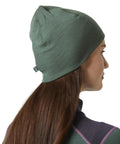 Person wearing Unisex Merino Wool Beanie With LIFA Technology, Jungle Green, One Size, moisture-wicking warmth for outdoor adventures