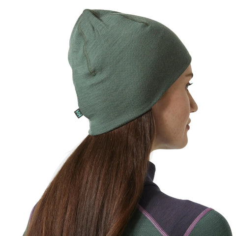 Person wearing Unisex Merino Wool Beanie With LIFA Technology, Jungle Green, One Size, moisture-wicking warmth for outdoor adventures