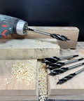 CORTOOL wood auger bit set, 1/2", 5/8", 3/4", 1" with quick-change hex shanks, five bits beside a cordless drill.
