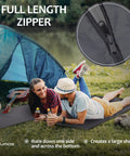 Couple relaxing on Silk Like Sleeping Bag Liner And Camping Sheet With Full Length Zipper For Travel, by a tent at a lake.