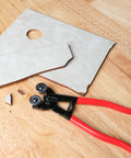 Glass Tile Nippers With Pro Grade Carbide Cutting Wheels And Comfy Grip on wooden surface with cut tile pieces