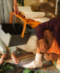 Person carrying a Portable Garden Tool Caddy With Locking Handle And Removable Bin, wall mountable, in a home setting.