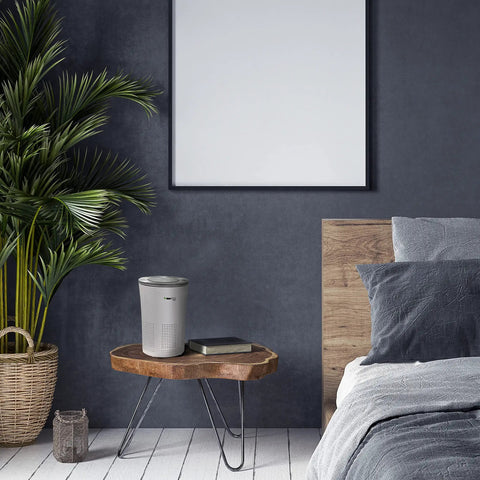 Premium Hepa Air Purifier With H13 True Filters And Uv Light Plus Activated Carbon on a wooden table in modern bedroom.