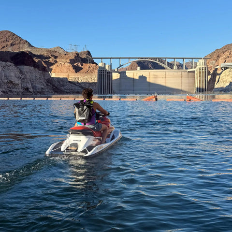 Person on a jet ski with 25L Waterproof Surf Backpack for Adventure with Roll Top Closure Keeps Gear Dry in Any Weather Built for the Grind
