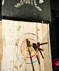 Axe and hammer stuck in wooden target; Battle Wolf Military Grade Survival Shovel Beefy Beastly Built Heavy Duty Carbon Steel visible.