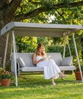 Oversized Outdoor Porch Swing Bed With Stand And Canopy Rain Cover Heavy Duty 3 Seat Bench Swing For Patio with woman sitting
