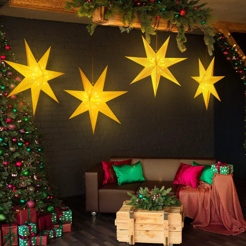 Two Pack 24 Inch Paper Star Lanterns With 50 LED Fairy String Lights Eight Modes Seven Pointed Hollow Star Hanging Decor For Indoor Outdoor Rooms Weddings Christmas Parties Lit Vibe illuminating a cozy living room.