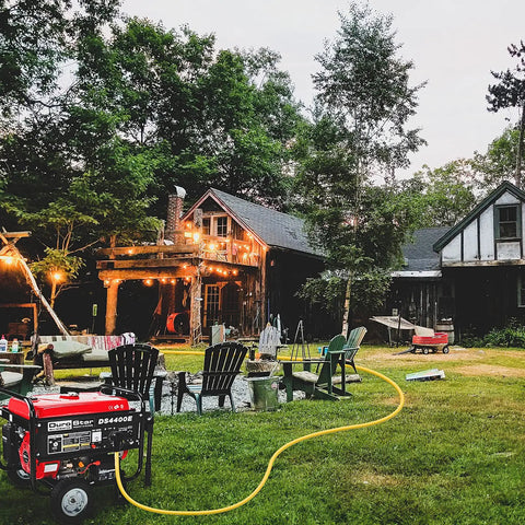 Outdoor scene with a generator connected by a Beefy 30 Foot 14-50P To SS2-50R 120V 240V 50 Amp Twist Lock Extension Cord for power