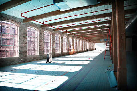 Interior with Aqua Shield Surface Protector 10 Mil 36 Inch By 100 Foot Heavy Duty Protective Film on floor of industrial space.