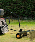 60 Inch Tow Behind Lawn Dethatcher With 24 Heavy Duty Spring Steel Tines attached to a lawn tractor, ready for yard work.