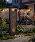 35 Inch Outdoor Water Fountain With Modern Curved Faux Slate Resin Waterfall And 2 Warm LED Lights displayed in garden setting