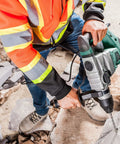 Worker using SDS Plus Rotary Hammer Drill Kit with 11 Pc Accessories on masonry surface, showcasing 12 Amp 1500W motor and 3 modes.