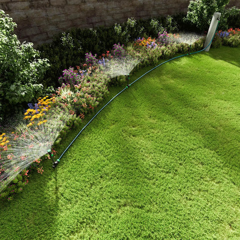 Flexible Sprinkler System With Metal Spike Base watering flower bed, Above Ground DIY Irrigation Kit in use, green lawn view