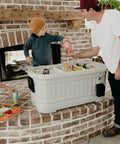 Family using 125 Qt Gray Party Bar Wheeled Cooler With Ultratherm Insulation Removable Lid That Converts To Open Air Beverage Tub