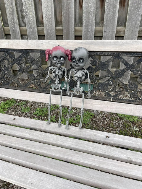 18 Inch Creepy Skeleton Boy Doll With Movable Joints, Durable All Weather Plastic, Realistic Bone Finish on a bench