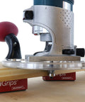 Dead Nuts Universal Compact Router Sub Base Quick Adjust Plate mounted on wood with swivel handles and bushing mounts.
