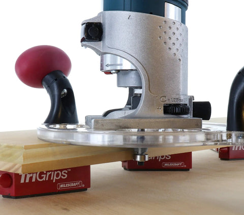 Dead Nuts Universal Compact Router Sub Base Quick Adjust Plate mounted on wood with swivel handles and bushing mounts.