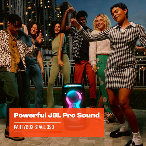 Group of people dancing beside the Stage 320 Portable Party Speaker with telescopic handle and wide wheels, outdoor setting