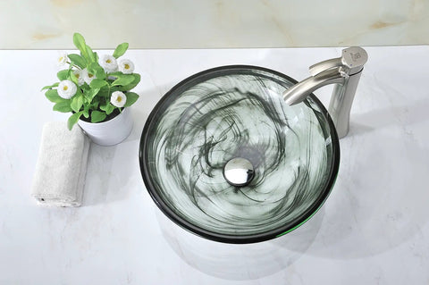 Overhead view of Mezzo Slumber Wisp Sleek Tempered Glass Vessel Sink Bowl In Grey Finish with pop-up drain, faucet, and decor. 