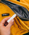 Zipper Lubricant Wax For Tents Drysuits Soft Coolers And More Includes 2 Sticks Non Toxic Silicone Free For Easy Unzipping In All Weather Against Sand Salt Chlorine And Rust, hand applying wax to tent zipper