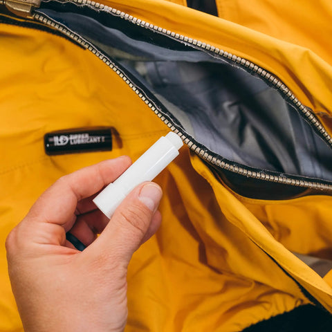 Zipper Lubricant Wax For Tents Drysuits Soft Coolers And More Includes 2 Sticks Non Toxic Silicone Free For Easy Unzipping In All Weather Against Sand Salt Chlorine And Rust, hand applying wax to tent zipper