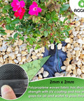 Pro Grade Premium Heavy Duty Weed Barrier Fabric installed under mulch and gravel, 2Ft by 50Ft, visible with flowers and rocks