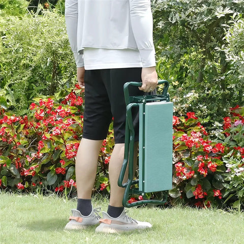 Person carrying Foldable Garden Kneeler And Seat With Tool Pouches in compact form among flowers, suitable for gardening tasks.