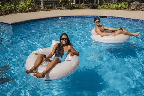 Two adults enjoying Motorized Pool Tube Float For Adults Pro 3.0 With 66W Motor Joystick Steering Phone Holder And Cup Holder Blue Finish