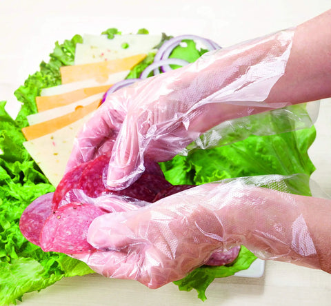 Hands wearing Disposable Food Safe Poly Gloves 1000 Count One Size Embossed Grip handling deli meat over lettuce.