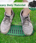Person standing on 4 Inch Green Angled Drainage Grate For Yard Drainage Systems That Fast Tracks Surface Water And Prevents Ponding