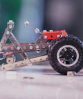 Close-up of a vehicle model from Beast Mode Erector Set Metal Model Kit For Adults Teens And Advanced Kids Build Cars Planes And Excavators With Realistic Pieces STEM Educational Toy And Engineering Challenge, showing metal parts and wheel assembly.