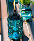 Topaz Blue Glass Outdoor Torches Two Pack, 65 Inch Weather Resistant Patio Lanterns For Backyard And Garden on table
