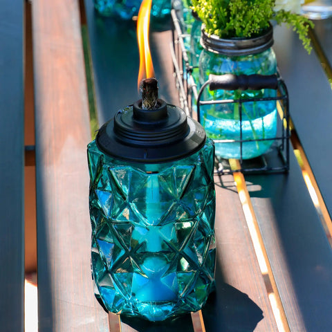Topaz Blue Glass Outdoor Torches Two Pack, 65 Inch Weather Resistant Patio Lanterns For Backyard And Garden on table