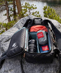 Backpack open on a rock with Go-To Nano 7 Ultra Light Hammock For Camping And Travel With Ripstop Nylon packed inside