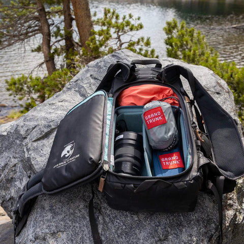 Backpack open on a rock with Go-To Nano 7 Ultra Light Hammock For Camping And Travel With Ripstop Nylon packed inside
