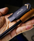 Close-up of Go-To 5.9 Inch Ferro Rod Fire Starter Kit with wooden handle and sheath in hand, waterproof flint steel ignition for survival.